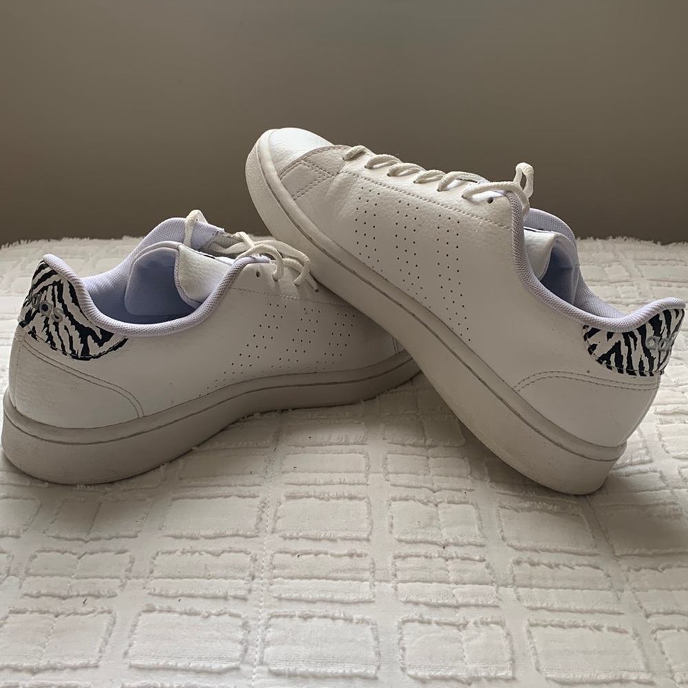 White Adidas sneakers.
